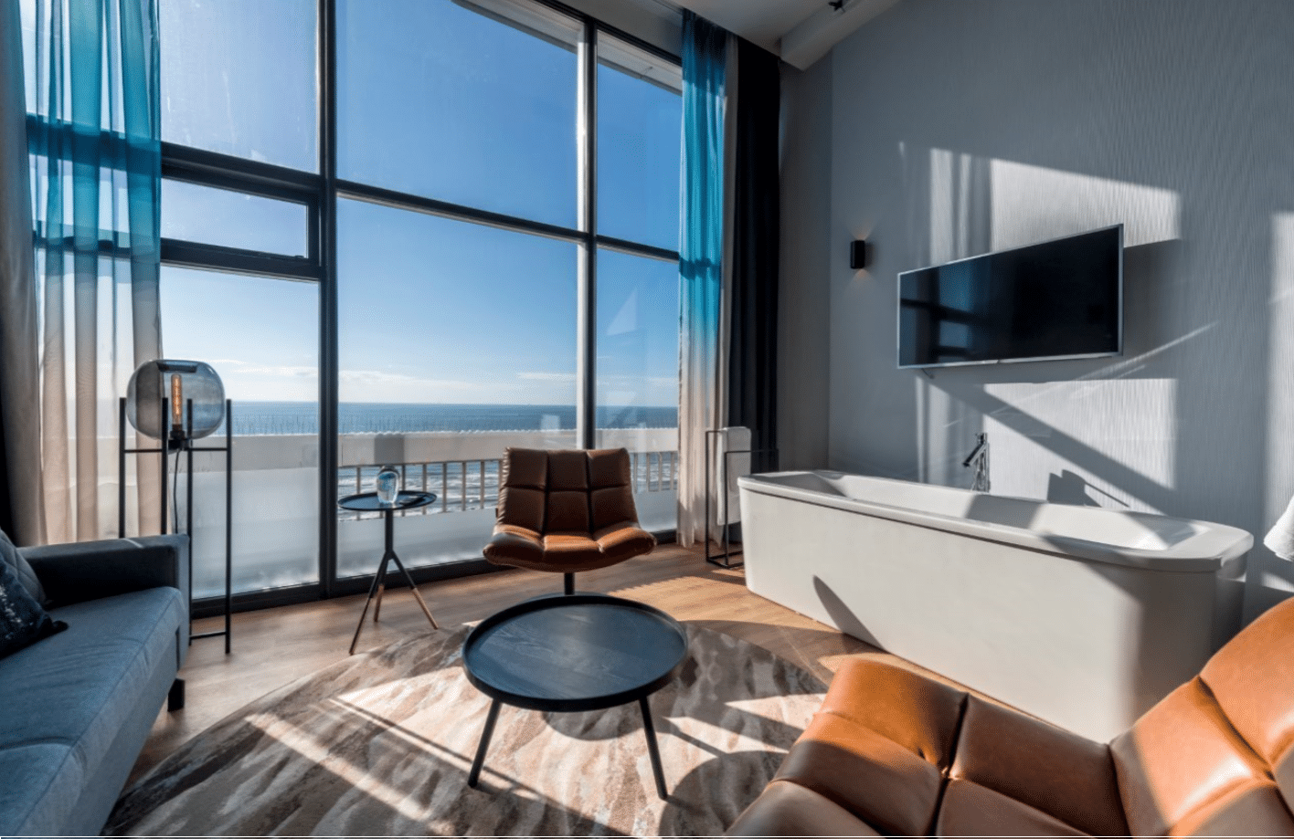 Palace Hotel Zandvoort - ein Zimmer mit einer Badewanne und einem Stuhl